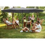 Happy friends eating and drinking beers at barbecue dinner on sunset time